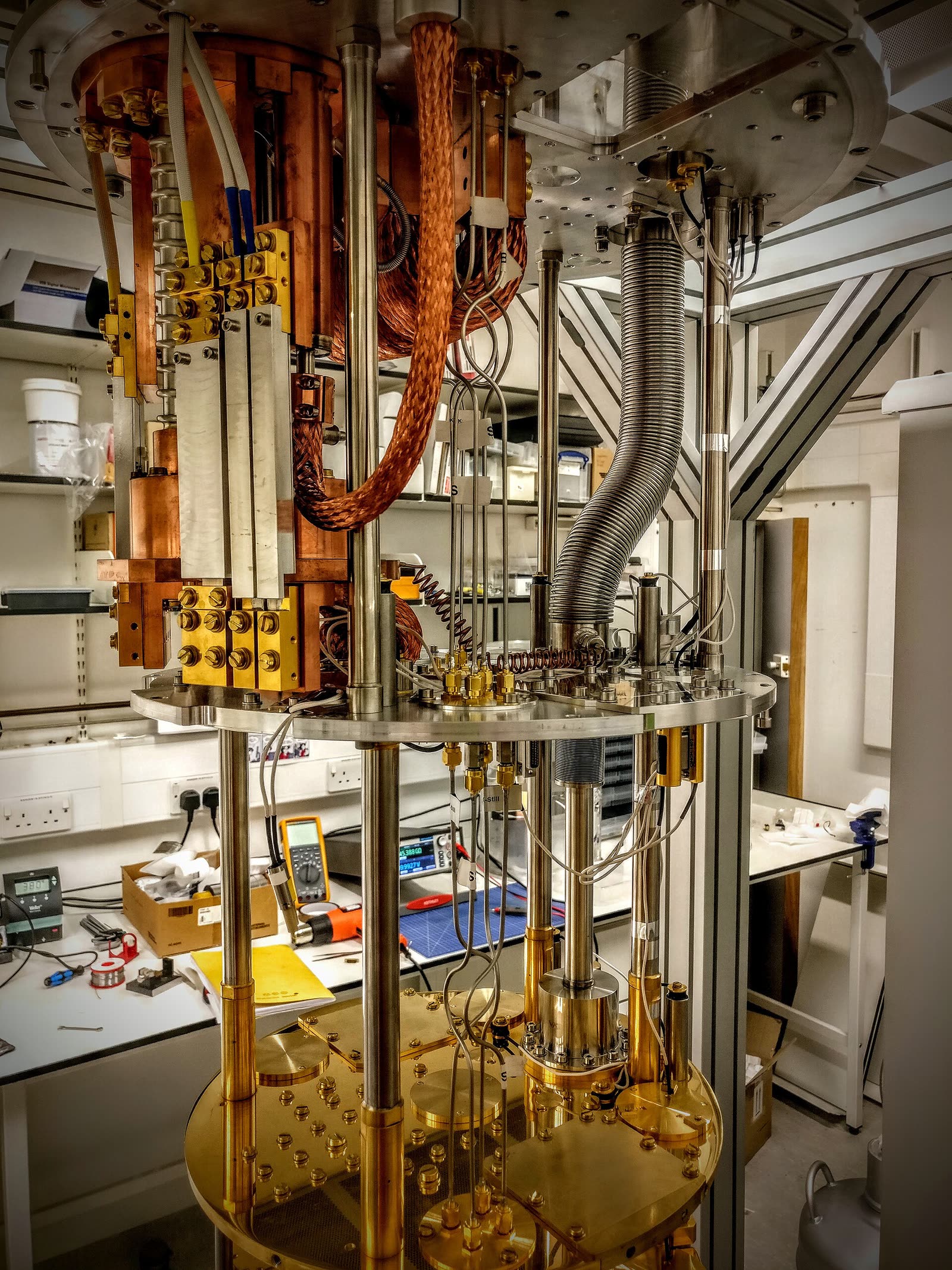 A dilution refrigerator, a tall stack of gold-plated plates used to hold a quantum computer near absolute zero